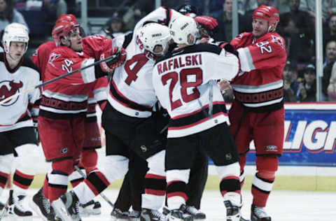 EAST RUTHERFORD, NEW JERSEY – MAY 12: Brian Rafalski #28 of the New Jersey Devils fights with Jeff O’Neill #92 of the Carolina Hurricanes in Game one of the Eastern Conference Quarterfinals of the 2001 NHL Playoffs on May 12, 2001 at Continental Airlines Arena in East Rutherford, New Jersey. The Devils won 5-1. (Photo by Jaime Squire/Getty Images/NHLI)