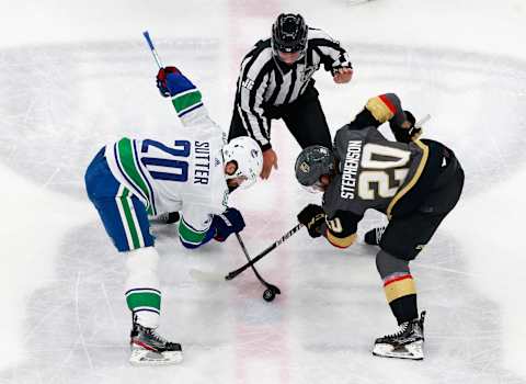 Linesman Jonny Murray #95 drops the puck between Chandler Stephenson #20 of the Vegas Golden Knights and Brandon Sutter #20 of the Vancouver Canucks in Game One of the Western Conference Second Round. (Photo by Jeff Vinnick/Getty Images)