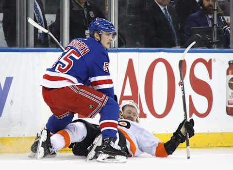 Jakub Voracek #93 of the Philadelphia Flyers is hit by Ryan Lindgren #55 of the New York Rangers