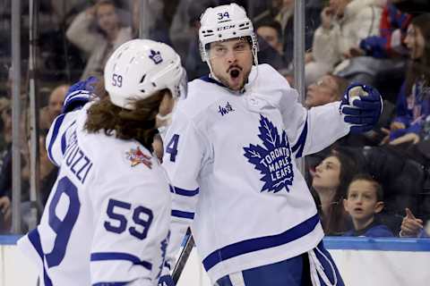 Dec 12, 2023; New York, New York, USA; Toronto Maple Leafs center Auston Matthews (34) celebrates his goal against the New York Rangers with left wing Tyler Bertuzzi (59) during the third period at Madison Square Garden. Mandatory Credit: Brad Penner-USA TODAY Sports