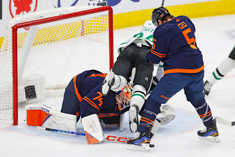 Nov 2, 2023; Edmonton, Alberta, CAN; Edmonton Oilers defensemen Cody Ceci (5) checks Dallas Stars forward Roope Hintz (24) over goaltender Stuart Skinner (74) during the third period at Rogers Place. Mandatory Credit: Perry Nelson-USA TODAY Sports