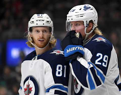 LOS ANGELES, CALIFORNIA – NOVEMBER 30: Kyle Connor #81 and Patrik Laine #29 of the Winnipeg Jets talk before a faceoff during the second period against the Los Angeles Kings at Staples Center on November 30, 2019 in Los Angeles, California. (Photo by Harry How/Getty Images)