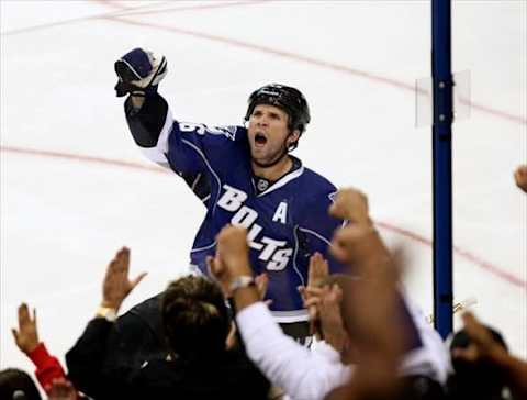 Oct 22, 2011; Tampa, FL, USA; Tampa Bay Lightning right wing Martin St. Louis (26) celebrates with the fans after scoring a goal against the Buffalo Sabers during the third period at St. Pete Times Forum. Tampa Bay defeated Buffalo 3-0. Mandatory Credit: Douglas Jones-USA TODAY Sports