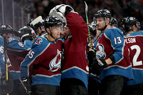 DENVER, COLORADO – OCTOBER 12: Andre Burakovsky #95 of the Colorado Avalanche is congratulated by his teammates after scoring the winning goal against the Arizona Coyotes in overtime at the Pepsi Center on October 12, 2019 in Denver, Colorado. (Photo by Matthew Stockman/Getty Images)