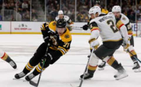 Dec 5, 2022; Boston, Massachusetts, USA; Boston Bruins left wing Taylor Hall (71) goes around Vegas Golden Knights defenseman Zach Whitecloud (2) during the first period at TD Garden. Mandatory Credit: Winslow Townson-USA TODAY Sports