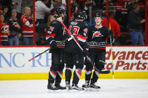 Mar 16, 2017; Raleigh, NC, USA; Carolina Hurricanes forward Victor Rask (49) is congratulated by forward Brock McGinn (23) and defensemen Jaccob Slavin (74) after his third period goal against the Minnesota Wild at PNC Arena. The Carolina Hurricanes defeated the Minnesota Wild 3-1. Mandatory Credit: James Guillory-USA TODAY Sports