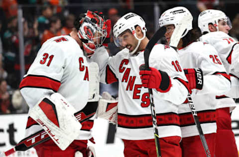 ANAHEIM, CALIFORNIA – NOVEMBER 18: Vincent Trocheck #16 and Ethan Bear #25 congratulate Frederik Andersen #31 of the Carolina Hurricanes after defeating the Anaheim Ducks 2-1 in a game at Honda Center on November 18, 2021, in Anaheim, California. (Photo by Sean M. Haffey/Getty Images)