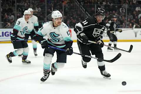 Nov. 29, 2022; Los Angeles, California, USA; LA Kings center Anze Kopitar (11) and Seattle Kraken left wing Brandon Tanev (13) battle for the puck in the second period at Crypto.com Arena. Mandatory Credit: Kirby Lee-USA TODAY Sports