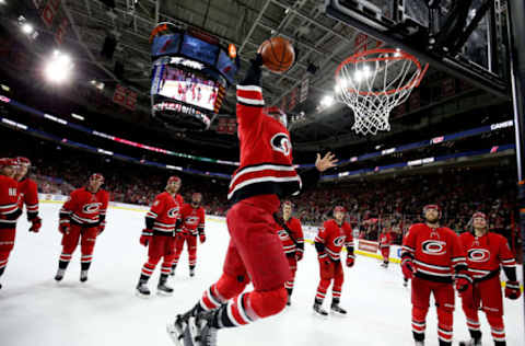 RALEIGH, NC – MARCH 23: Trevor van Riemsdyk #57 of the Carolina Hurricanes dunks a basketball during the Storm Surge following an NHL game against the Minnesota Wild on March 23, 2019 at PNC Arena in Raleigh, North Carolina. (Photo by Gregg Forwerck/NHLI via Getty Images)