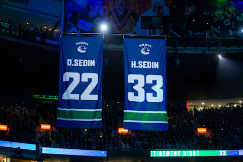 The banners of Daniel and Henrik Sedin are raised to the rafters (Photo by Ben Nelms/Getty Images)