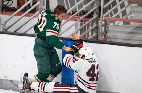 TRAVERSE CITY, MI – SEPTEMBER 10: Drake Pilon #70 of the Minnesota Wild fights with Riley McKay #42 of the Chicago Blackhawks during Day-5 of the NHL Prospects Tournament at Centre Ice Arena on September 10, 2019 in Traverse City, Michigan. (Photo by Dave Reginek/NHLI via Getty Images)