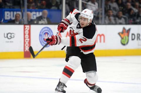 November 19, 2016; Los Angeles, CA, USA; New Jersey Devils defenseman John Moore (2) shoots on goal against the Los Angeles Kings during the first period at Staples Center. Mandatory Credit: Gary A. Vasquez-USA TODAY Sports