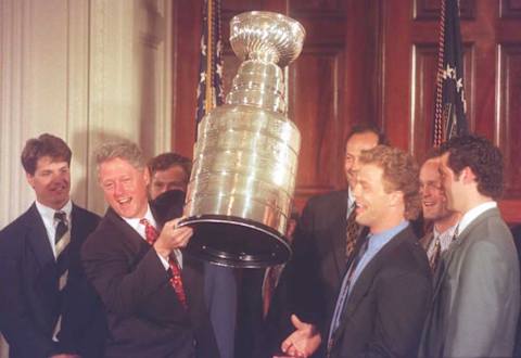 U.S. President Bill Clinton holds up the Stanley Cup (JOYCE NALTCHAYAN/AFP via Getty Images)