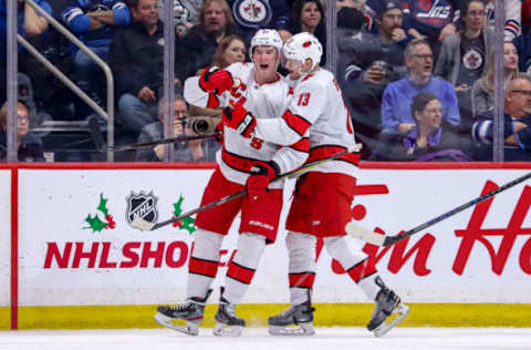 WINNIPEG, MB – DECEMBER 17: Andrei Svechnikov #37 and Warren Foegele #13 of the Carolina Hurricanes celebrate a second period goal against the Winnipeg Jets at the Bell MTS Place on December 17, 2019 in Winnipeg, Manitoba, Canada. (Photo by Darcy Finley/NHLI via Getty Images)