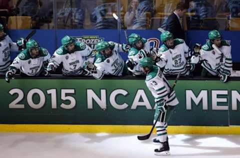 Apr 9, 2015; Boston, MA, USA; University of North Dakota forward Connor Gaarder (13) skates past the bench after scoring against the Boston University Terriers during the third period in a semifinal game in the men