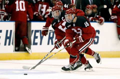 MANCHESTER, NH – MARCH 29: Harvard Crimson defenseman Adam Fox (18) carries the puck during a Northeast Regional semi-final between the UMASS Minutemen and the Harvard Crimson on March 29, 2019, at SNHU Arena in Manchester, NH. (Photo by Fred Kfoury III/Icon Sportswire via Getty Images)