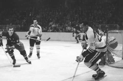 NEW YORK, NY – 1961: Willie O’Ree #25 of the Boston Bruins skates with the puck as Camille Henry #21 of the New York Rangers looks defend during their NHL game circa 1961 at the Madison Square Garden in New York, New York. (Photo by Bruce Bennett Studios/Getty Images)