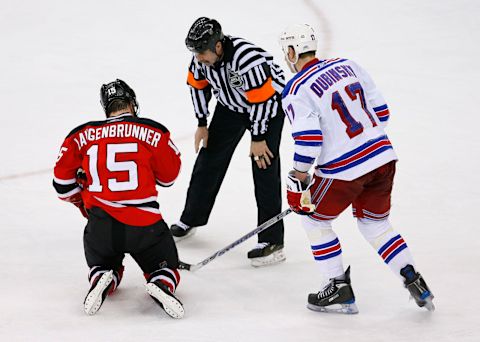 Referee Bill McCreary checks on New Jersey Devils right wing Jamie Langenbrunner: Ed Mulholland-USA TODAY Sports