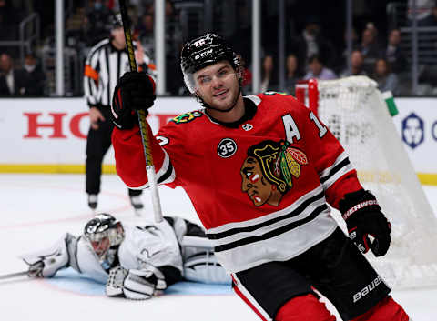 LOS ANGELES, CALIFORNIA – MARCH 24: Alex DeBrincat #12 of the Chicago Blackhawks celebrates his goal past Jonathan Quick #32 of the Los Angeles Kings, to clinch a 4-3 win in an overtime shootout at Crypto.com Arena on March 24, 2022 in Los Angeles, California. (Photo by Harry How/Getty Images)