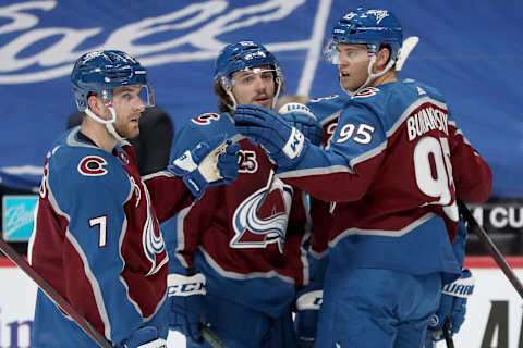 DENVER, COLORADO – MARCH 16: Andre Burakovsky #95 of the Colorado Avalanche celebrates with Devon Toews #7 and Samuel Girard #49 after scoring against the Anaheim Ducks in the second period at Ball Arena on March 16, 2021 in Denver, Colorado. (Photo by Matthew Stockman/Getty Images)