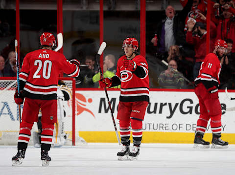 RALEIGH, NC – MARCH 13: Teuvo Teravainen #86 of the Carolina Hurricanes is congratulated by teammate Sebastian Aho #20 after scoring a goal during an NHL game against the Boston Bruins on March 13, 2018 at PNC Arena in Raleigh, North Carolina. (Photo by Gregg Forwerck/NHLI via Getty Images)