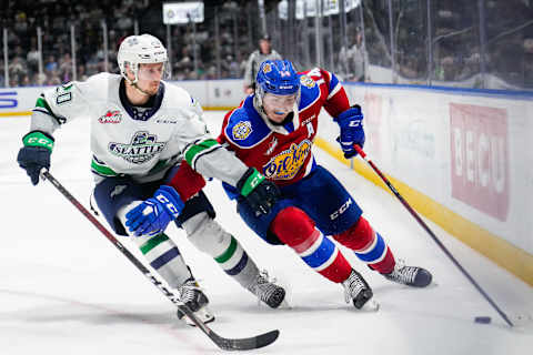 KENT, WASHINGTON – JUNE 07: Josh Williams #14 of the Edmonton Oil Kings tries to skate the puck around Samuel Knazko #20 of the Seattle Thunderbirds during the third period of Game 3 of the Western Hockey League Championship at accesso ShoWare Center on June 07, 2022 in Kent, Washington. (Photo by Christopher Mast/Getty Images)