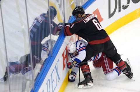 TORONTO, ONTARIO – AUGUST 03: Joel Edmundson #6 of the Carolina Hurricanes pins Ryan Strome #16 of the New York Rangers to the boards in Game Two of the Eastern Conference Qualification Round prior to the 2020 NHL Stanley Cup Playoffs at Scotiabank Arena on August 3, 2020, in Toronto, Ontario, Canada. (Photo by Andre Ringuette/Freestyle Photo/Getty Images)