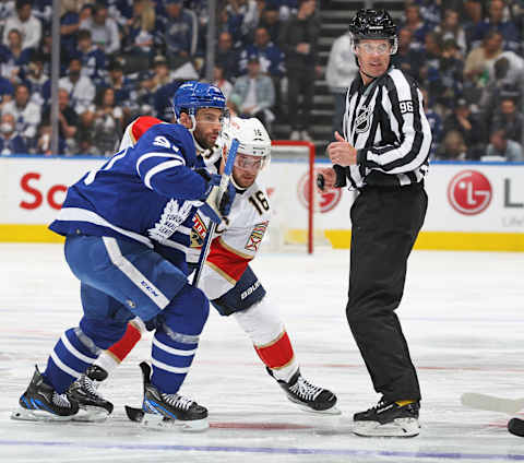 TORONTO, CANADA – MAY 12: Linseman David Brisebois #96 drops the puck between Aleksander Barkov #16 of the Florida Panthers and John Tavares #91 of the Toronto Maple Leafs  . (Photo by Claus Andersen/Getty Images)