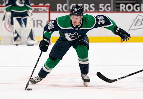 VANCOUVER, BC – FEBRUARY 19: Nils Hoglander #36 of the Vancouver Canucks skates with the puck during NHL hockey action. (Photo by Rich Lam/Getty Images)