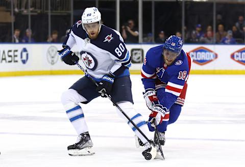 NEW YORK, NEW YORK – APRIL 19: Andrew Copp #18 of the New York Rangers steals the puck from Pierre-Luc Dubois #80 of the Winnipeg Jets during the first period at Madison Square Garden on April 19, 2022 in New York City. (Photo by Elsa/Getty Images)