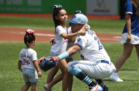 TORONTO, ON – JUNE 17: Yangervis Solarte #26 of the Toronto Blue Jays is greeted by his daughters on Fathers Day before the start of MLB game action against the Washington Nationals at Rogers Centre on June 17, 2018 in Toronto, Canada. (Photo by Tom Szczerbowski/Getty Images)