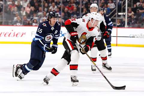 Winnipeg Jets, Mark Scheifele (55); Ottawa Senators, Mike Reilly (5) Mandatory Credit: James Carey Lauder-USA TODAY Sports