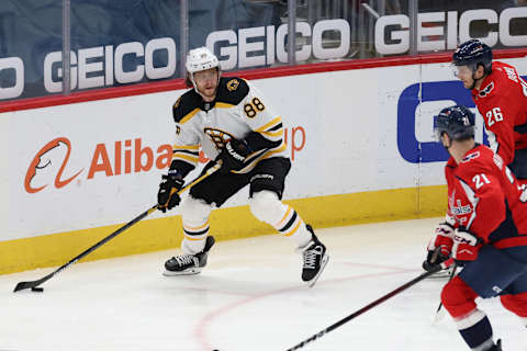 Feb 1, 2021; Washington, District of Columbia, USA; Boston Bruins right wing David Pastrnak (88) skates with the puck as Washington Capitals right wing Garnet Hathaway (21) defends in the third period at Capital One Arena. Mandatory Credit: Geoff Burke-USA TODAY Sports