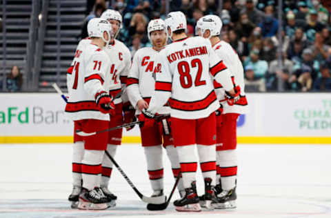 SEATTLE, WASHINGTON – NOVEMBER 24: The Carolina Hurricanes gather during the third period against the Seattle Kraken at Climate Pledge Arena on November 24, 2021, in Seattle, Washington. (Photo by Steph Chambers/Getty Images)