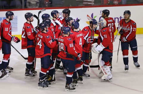 Oct 3, 2016; Washington, DC, USA; Washington Capitals goalie Philipp Grubauer (31) celebrates with teammates after their game against the St. Louis Blues at Verizon Center. The Capitals won 2-1 in a shootout. Mandatory Credit: Geoff Burke-USA TODAY Sports