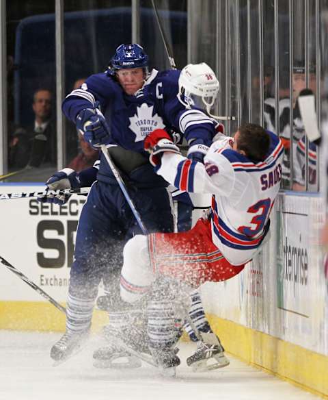 NEW YORK, NY – DECEMBER 05: Dion Phaneuf #3 of the Toronto Maple Leafs hits Michael Sauer #38 of the New York Rangers in the third period at Madison Square Garden on December 5, 2011 in New York City. The Leafs defeated the Rangers 4-2. (Photo by Bruce Bennett/Getty Images)