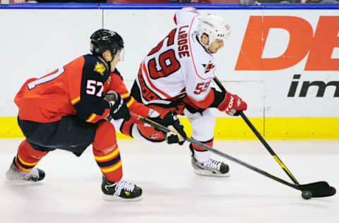 SUNRISE, FL – APRIL 7: Chad LaRose #59 of the Carolina Hurricanes and Marcel Goc #57 of the Florida Panthers go after the puck during a NHL game at the BankAtlantic Center on April 7, 2012 in Sunrise, Florida. (Photo by Ronald C. Modra/Getty Images)