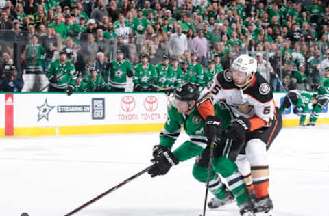 DALLAS, TX: Antoine Roussel #21 of Dallas tries to keep the puck away from Marcus Pettersson #65 of the Anaheim Ducks on March 9, 2018. (Photo by Glenn James/NHLI via Getty Images)