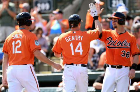 Mar 8, 2017; Sarasota, FL, USA; Baltimore Orioles outfielder Craig Gentry (14) is greeted by catchers Caleb Joseph (36) and outfielder Seth Smith (12) after hitting a three run home run in the second inning of the spring training game against the Toronto Blue Jays at Ed Smith Stadium. Mandatory Credit: Jonathan Dyer-USA TODAY Sports