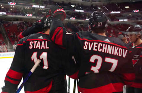 Mar 9, 2021; Raleigh, North Carolina, USA; Carolina Hurricanes center Jordan Staal (11) is congratulated after his overtime goal by right wing Andrei Svechnikov (37) against the Nashville Predators at PNC Arena. Mandatory Credit: James Guillory-USA TODAY Sports