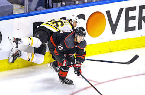 David Krejci #46 of the Boston Bruins is checked by Sebastian Aho #20 of the Carolina Hurricanes (Photo by Elsa/Getty Images)