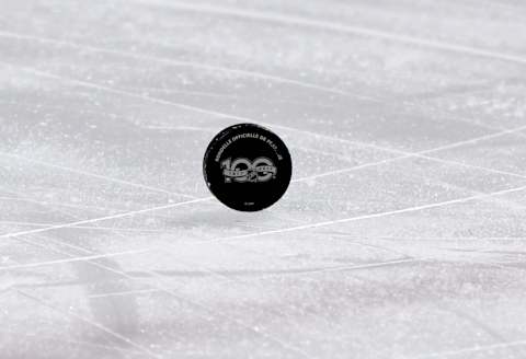 Puck with the 100th anniversary logo: (Eric Bolte-USA TODAY Sports)