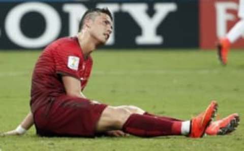 Jun 22, 2014; Manaus, Amazonas, BRAZIL; Portugal forward Cristiano Ronaldo (7) sits on the ground after being knocked down during the second half of a 2-2 tie with the United States in a 2014 World Cup game at Arena Amazonia. Mandatory Credit: Winslow Townson-USA TODAY Sports