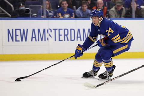 Feb 15, 2022; Buffalo, New York, USA; Buffalo Sabres center Dylan Cozens (24) moves the puck against the New York Islanders during the second period at KeyBank Center. Mandatory Credit: Timothy T. Ludwig-USA TODAY Sports