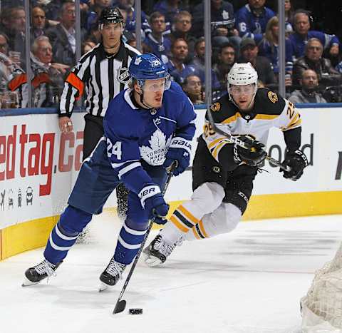 TORONTO, ON – APRIL 17: Brandon Carlo #25 of the Boston Bruins chases after Kasperi Kapanen #24 of the Toronto Maple Leafs in Game Four of the Eastern Conference First Round during the 2019 NHL Stanley Cup Playoffs at Scotiabank Arena on April 17, 2019 in Toronto, Ontario, Canada. The Bruins defeated the Maple Leafs 6-4. (Photo by Claus Andersen/Getty Images)