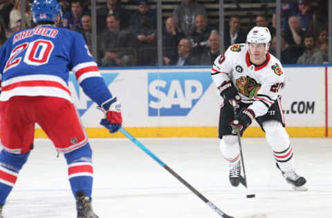 NEW YORK, NY – JANUARY 17: Brandon Saad #20 of the Chicago Blackhawks skates with the puck against Chris Kreider #20 of the New York Rangers at Madison Square Garden on January 17, 2019 in New York City. The New York Rangers won 4-3. (Photo by Jared Silber/NHLI via Getty Images)