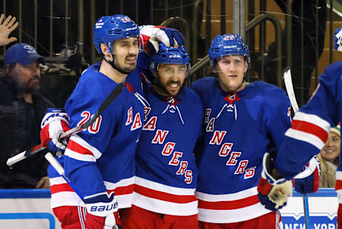 NEW YORK, NEW YORK – DECEMBER 12: Vincent Trocheck #16 of the New York Rangers (C) celebrates his powerplay goal against the New Jersey Devils at 13:58 of the second period and is joined by Chris Kreider #20 (L) and Adam Fox #23 (R) at Madison Square Garden on December 12, 2022, in New York City. (Photo by Bruce Bennett/Getty Images)