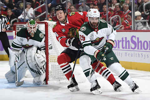 CHICAGO, IL – NOVEMBER 18: John Hayden #40 of the Chicago Blackhawks and Greg Pateryn #29 of the Minnesota Wild skate around the net guarded by goalie Alex Stalock #32 in the first period at the United Center on November 18, 2018 in Chicago, Illinois. (Photo by Bill Smith/NHLI via Getty Images)