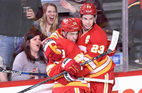 Feb 27, 2016; Calgary, Alberta, CAN; Calgary Flames left wing Johnny Gaudreau (13) celebrates his second period goal with center Sean Monahan (23) against the Ottawa Senators at Scotiabank Saddledome. Mandatory Credit: Candice Ward-USA TODAY Sports