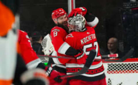 Mar 9, 2023; Raleigh, North Carolina, USA; Carolina Hurricanes goaltender Pyotr Kochetkov (52) celebrates their victory with defenseman Brent Burns (8) against the Philadelphia Flyers at PNC Arena. Mandatory Credit: James Guillory-USA TODAY Sports